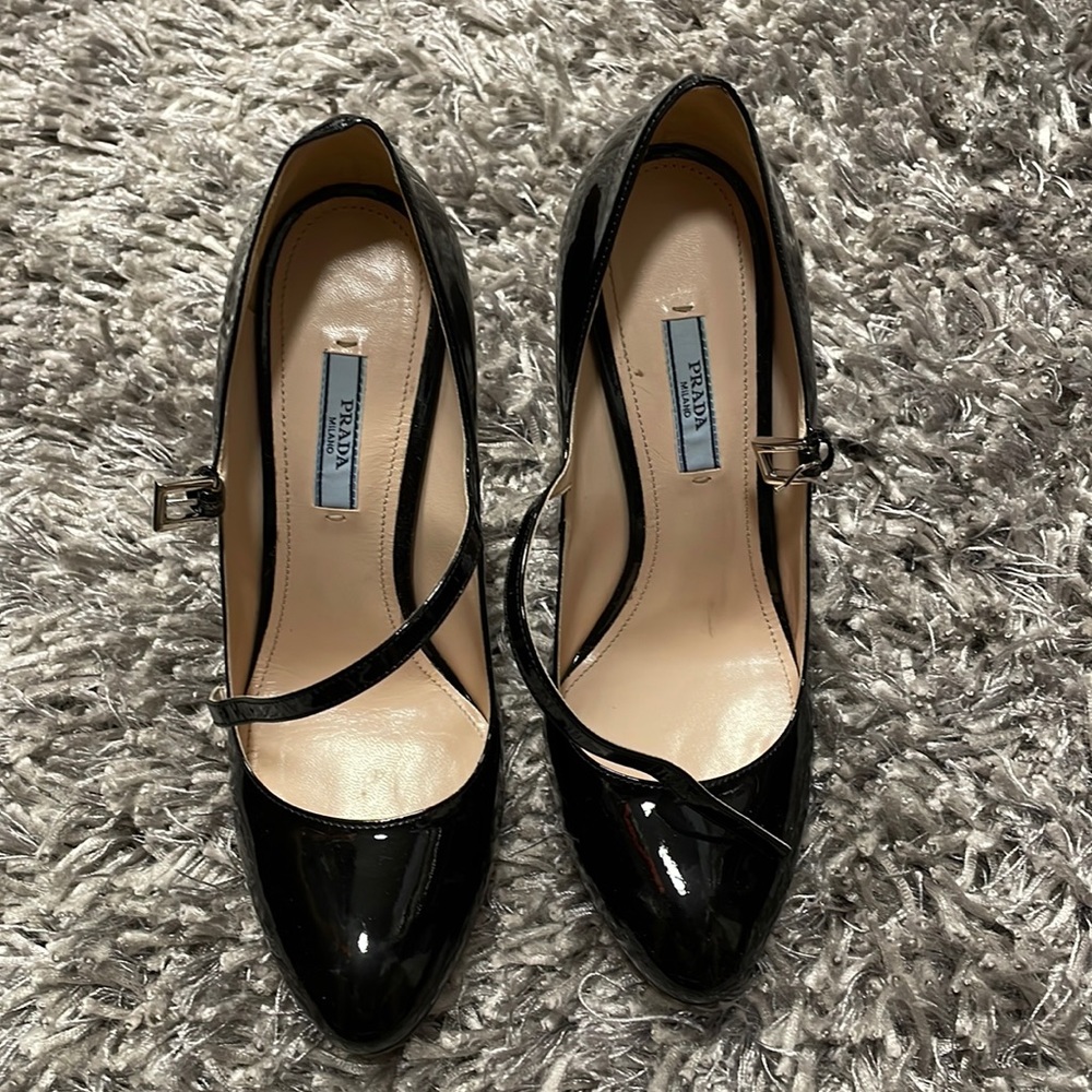 Black patent leather Prada strap pumps